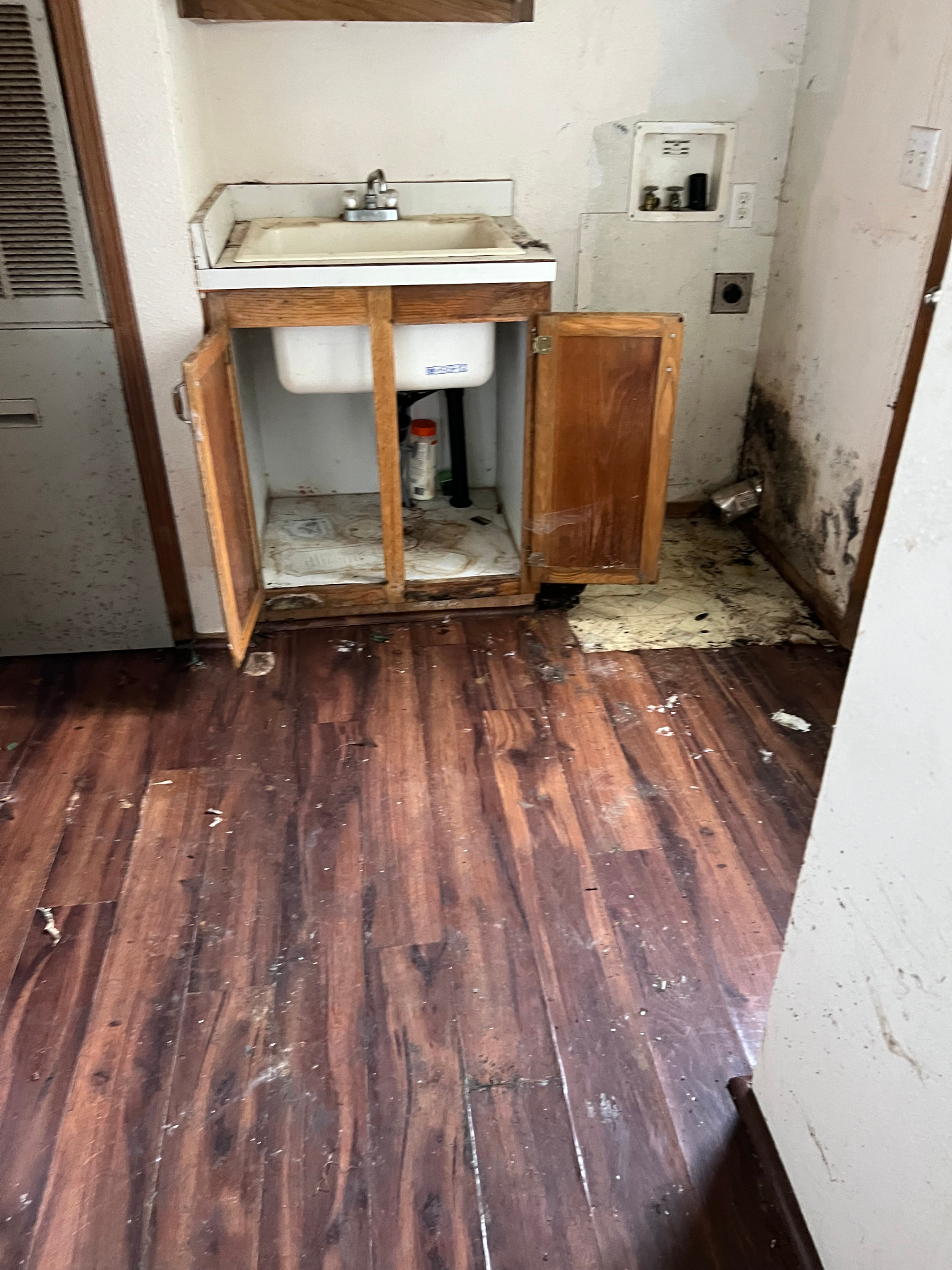 Utility room after hauling out an old sink and washer for a full cleanout
