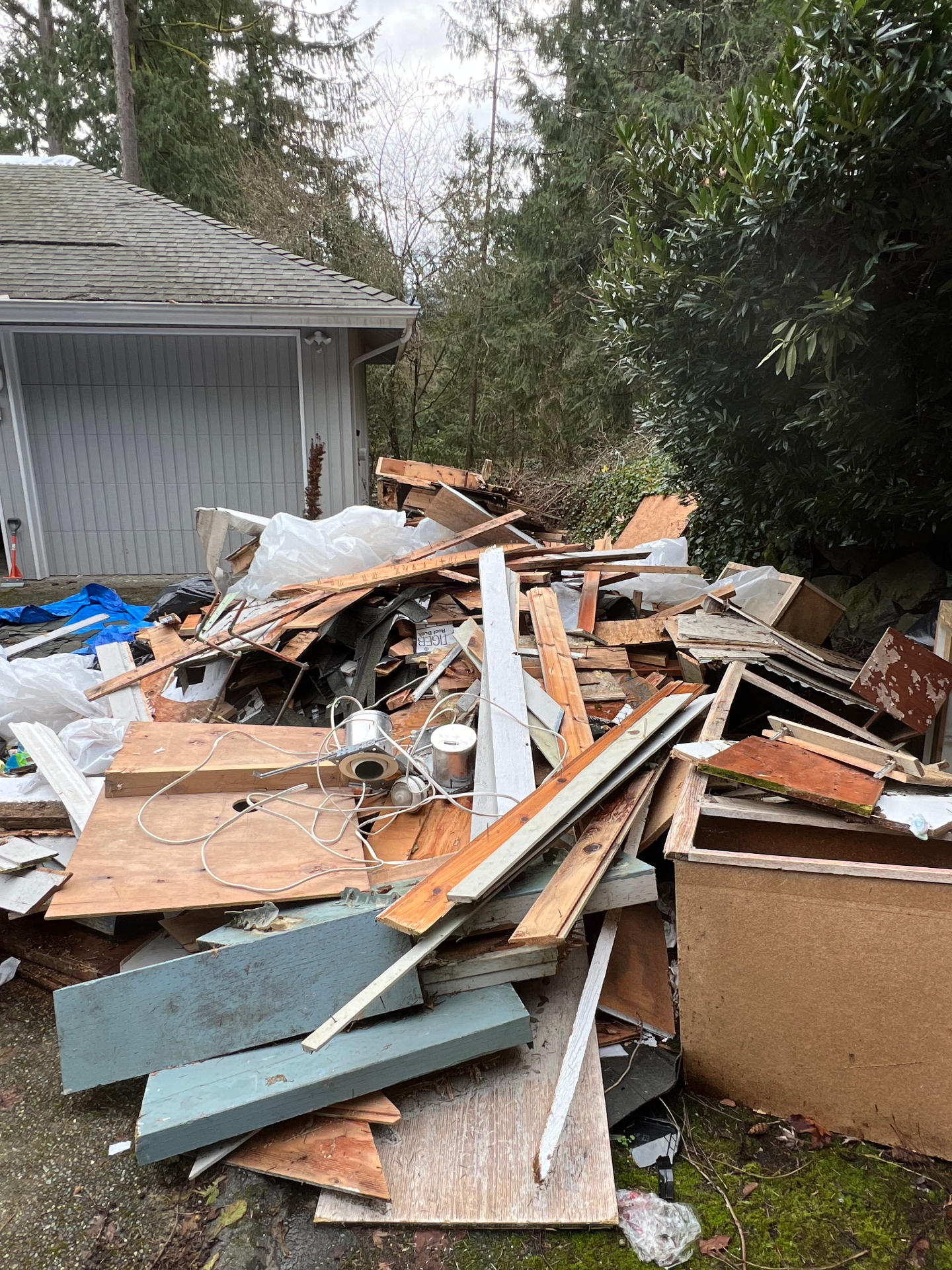 Construction debris pile in a residential driveway ready for haul away