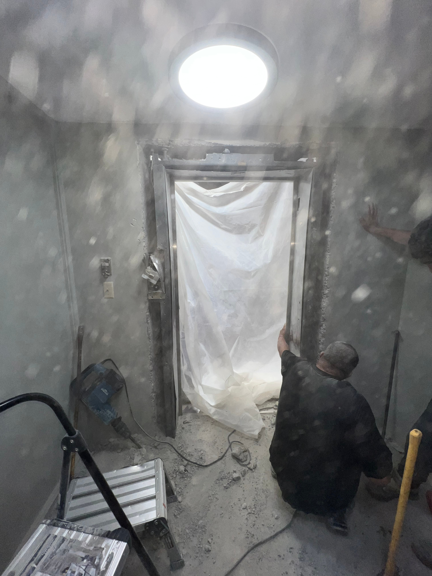 Concrete demolition work underway inside a commercial space