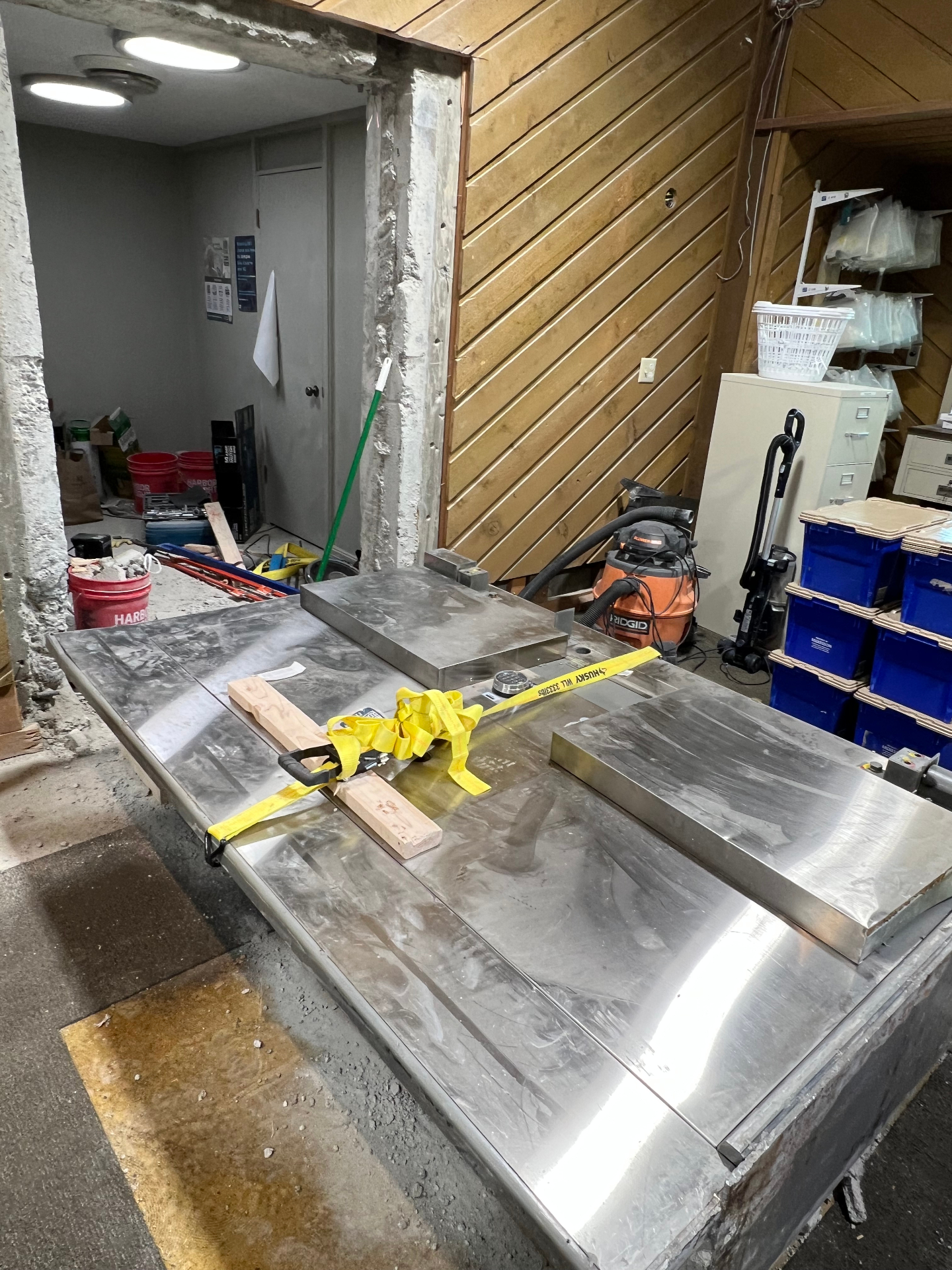 Stainless steel commercial equipment strapped and prepped for haul out during an interior demolition