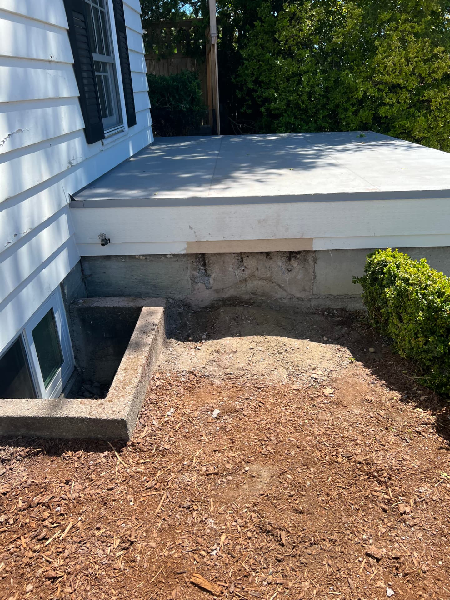 Side of the home fully cleared after concrete stair removal and haul away