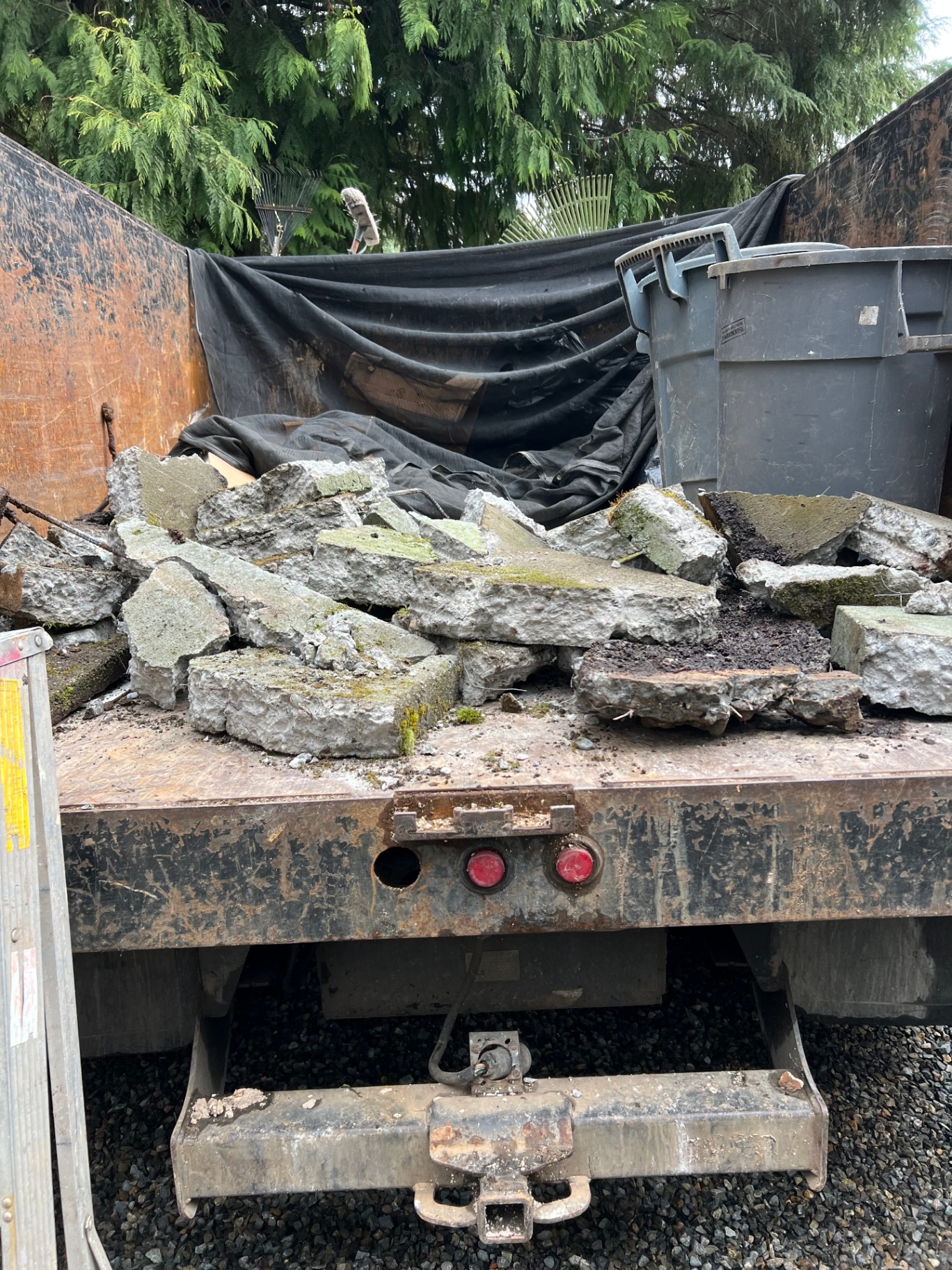 Dump truck loaded with broken concrete from a hardscape tearout