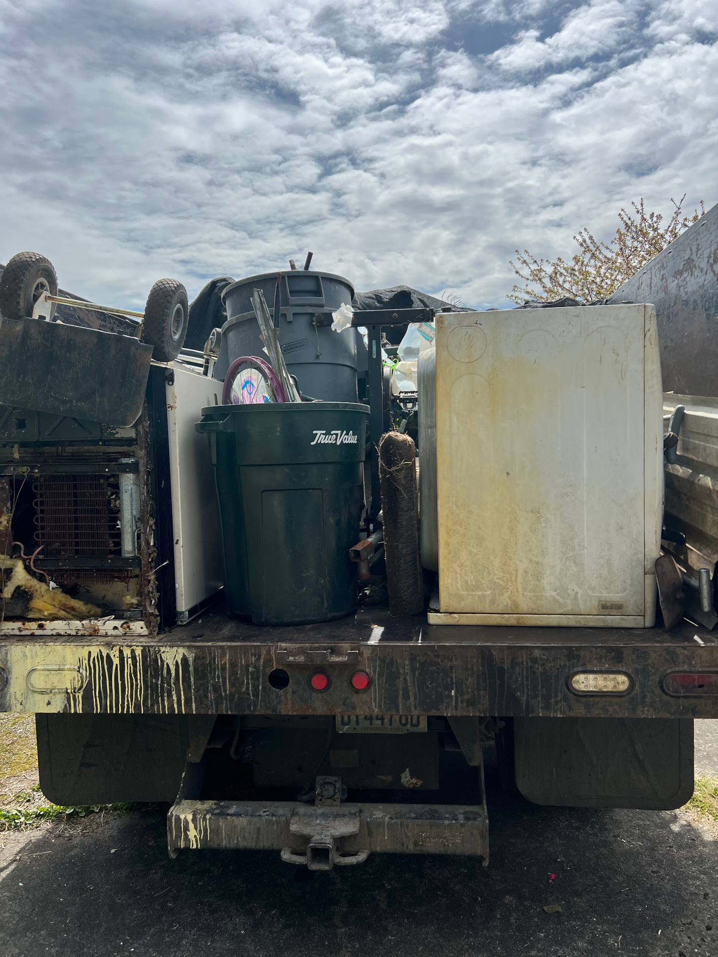 Anderson's truck loaded with appliances, furniture, and bulky household items during a full cleanout