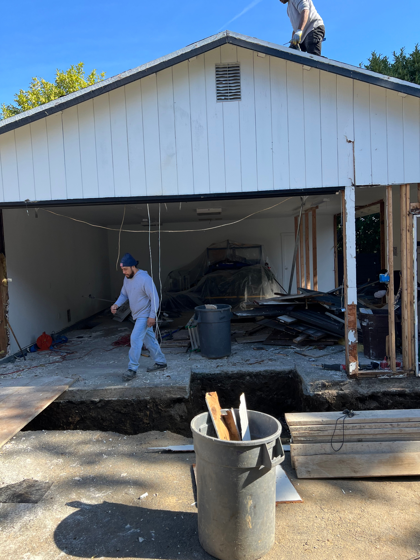 Garage demolition and debris removal in progress