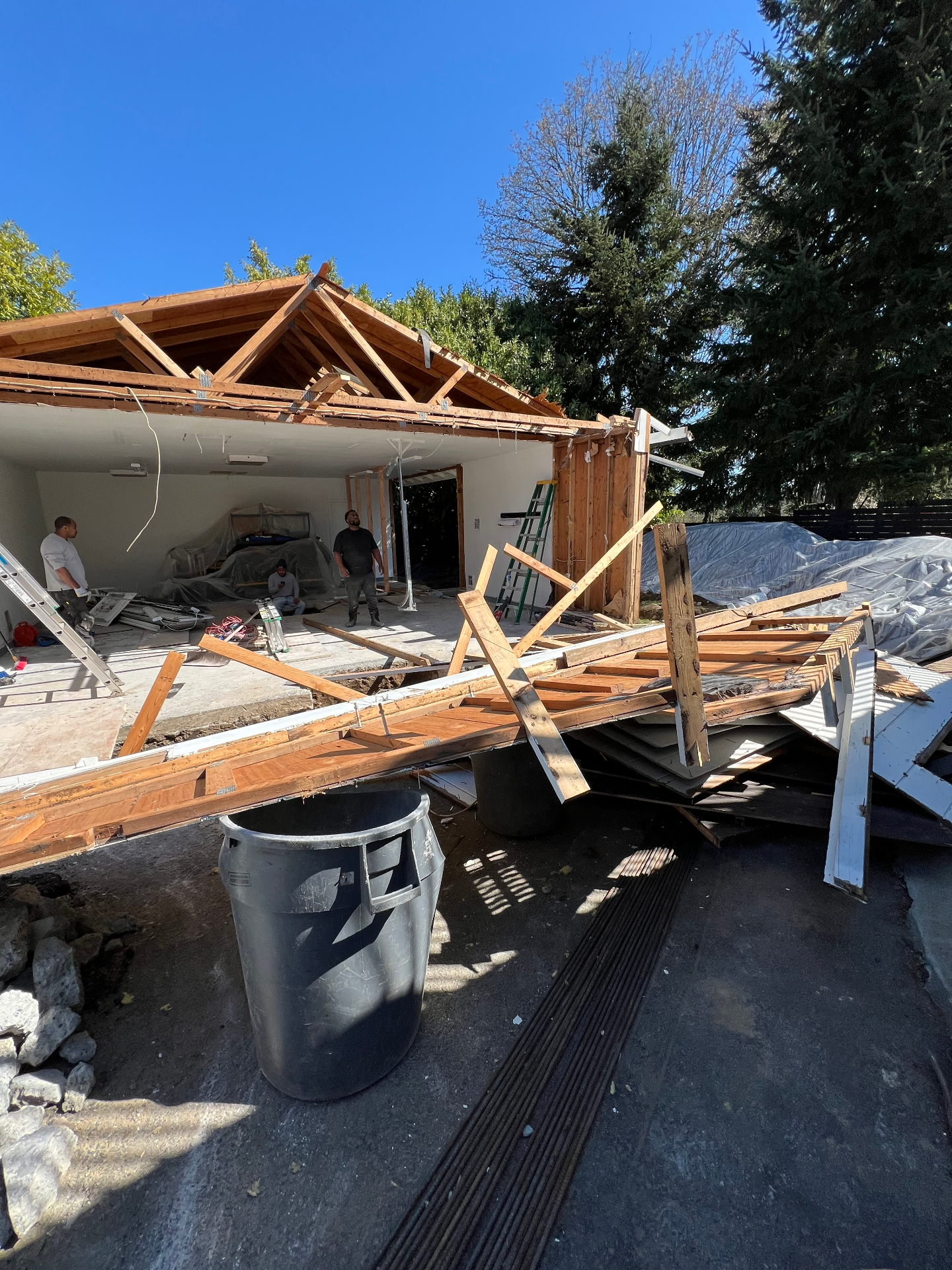 Crew hauling framing lumber and construction debris